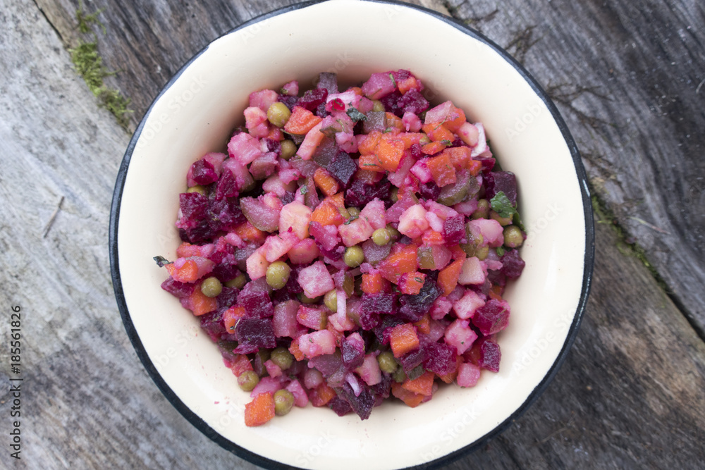 Vinaigrette of beets, potatoes, pickles, onions, carrots, green peas, herbs and seasonings. Beautiful salad close-up.