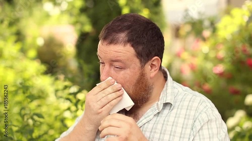 A bearded man suffers from pollen photo