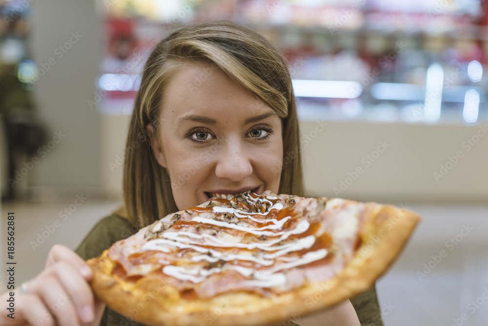 Beautiful girl eating tasty pizza on light background. Happy woman eating tasty pizza. leisure, food and drinks, people and holidays concept. Beautiful girl eating tasty pizza on light background. Happy woman eating tasty pizza. leisure, food and drinks, people and holidays concept.