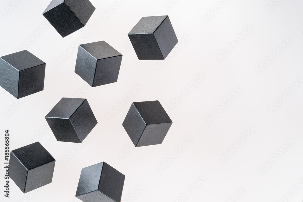Black wooden cube shapes are floating. Concept of creative, logical thinking. Abstract geometric real floating wooden cube. Black wooden cube shapes are floating. Concept of creative, logical thinking. Abstract geometric real floating wooden cube.