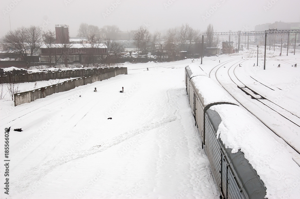 Top view of freight train with carriages on railways at winter. Selectuve focus