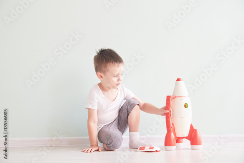 Active little boy playing the rocket toys, Child showing rocket toy with happy face, Children or Toddler learning and Development concept photo