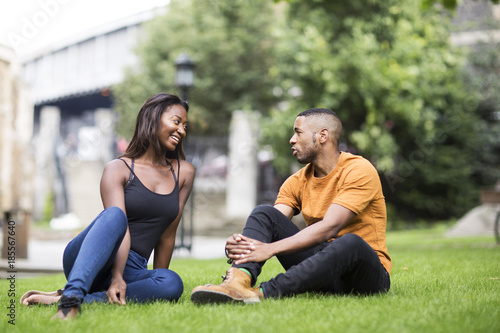 young couple sitting in the park together