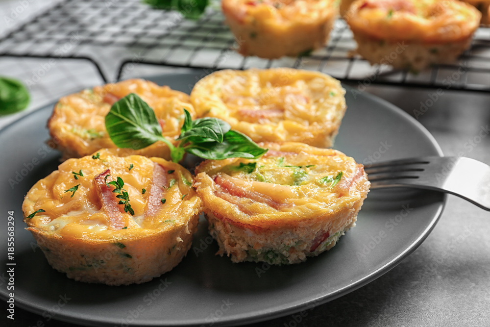 Plate with tasty egg muffins on table, closeup