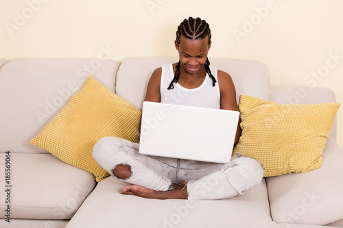 Cheerful black man with laptop photo