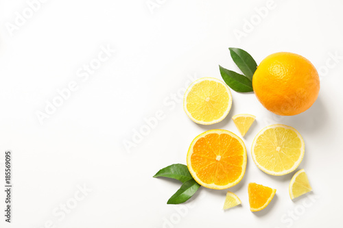 Composition with ripe lemons and oranges on white background