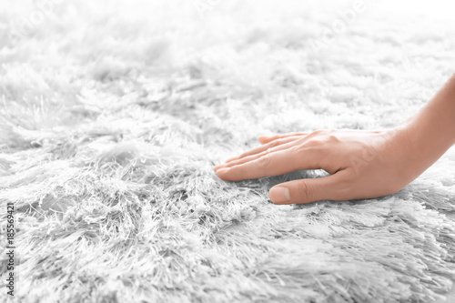 Slika na platnu Woman touching carpet, closeup