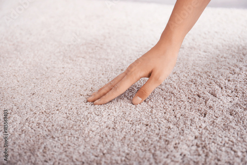 Obraz na plátně Woman touching carpet, closeup