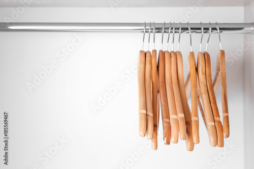 Clothes hangers in empty wardrobe photo
