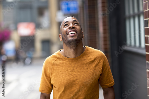 happy young man looking up