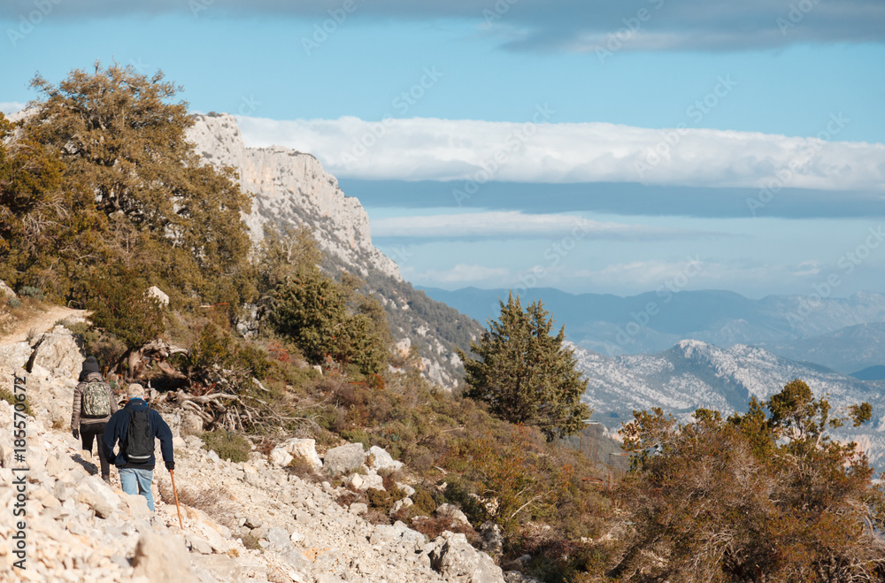 woman and man hiking in the trail to Gola su gorroppu - activity and health concept