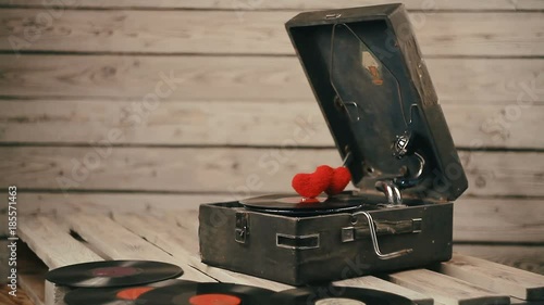 two hearts spinning on vinyl record on a vintage gramophone photo