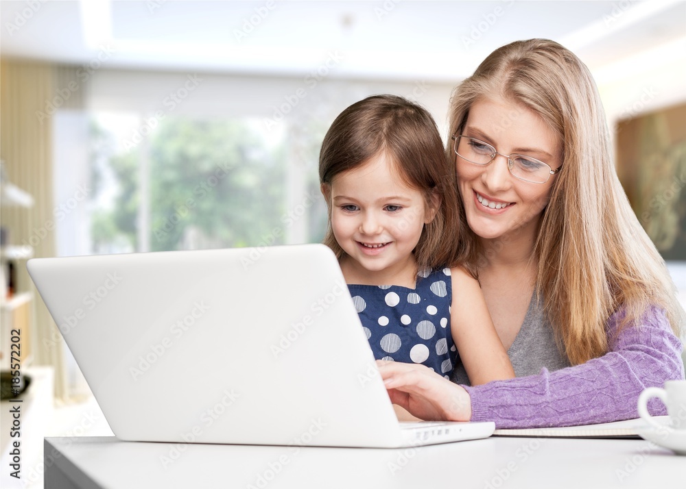Mother and daughter using laptop Mother and daughter using laptop