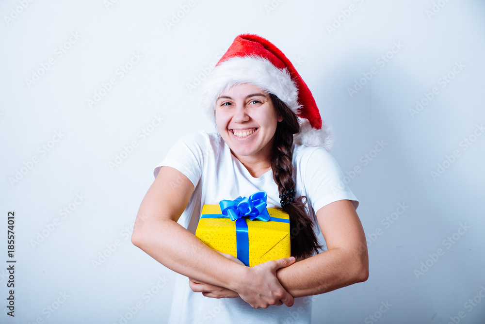 young pretty woman hold present box in santa hat young pretty woman hold present box in santa hat