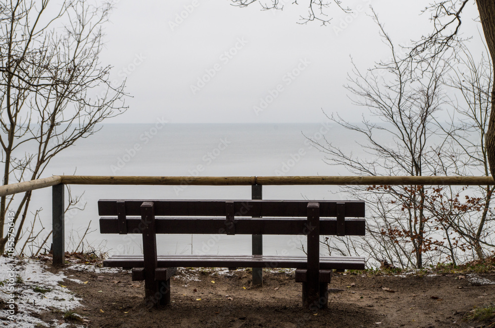 Empty bench on the shore of the ocean on a winter day. Empty bench on the shore of the ocean on a winter day.