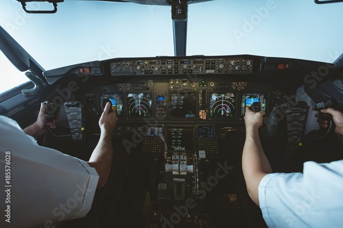 Pilot and copilot flying an airplane photo
