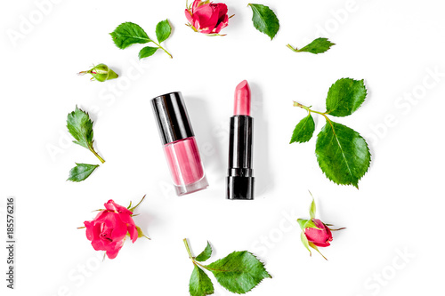 berry color decorative cosmetics with roses white background top
