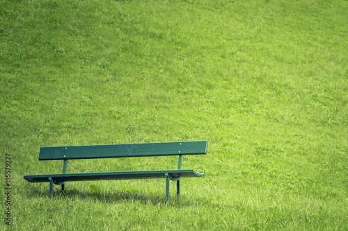 Abandoned park bench in apublic garden.