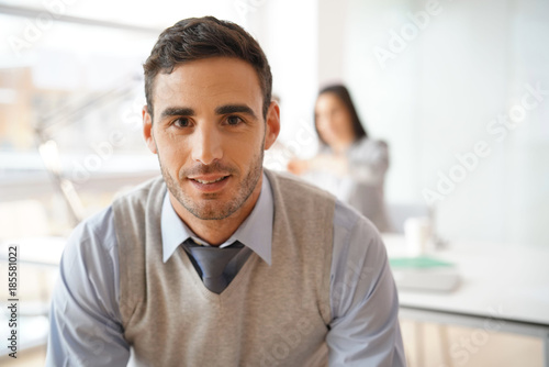 Portrait of young businessman looking at camera