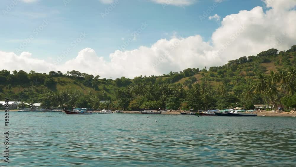 Boat view arriving paradise island beach Nusa Lembongan port Bali with boats on shore palm trees Lombok Bali Indonesia July 2017 Boat view arriving paradise island beach Nusa Lembongan port Bali with boats on shore palm trees Lombok Bali Indonesia July 2017
