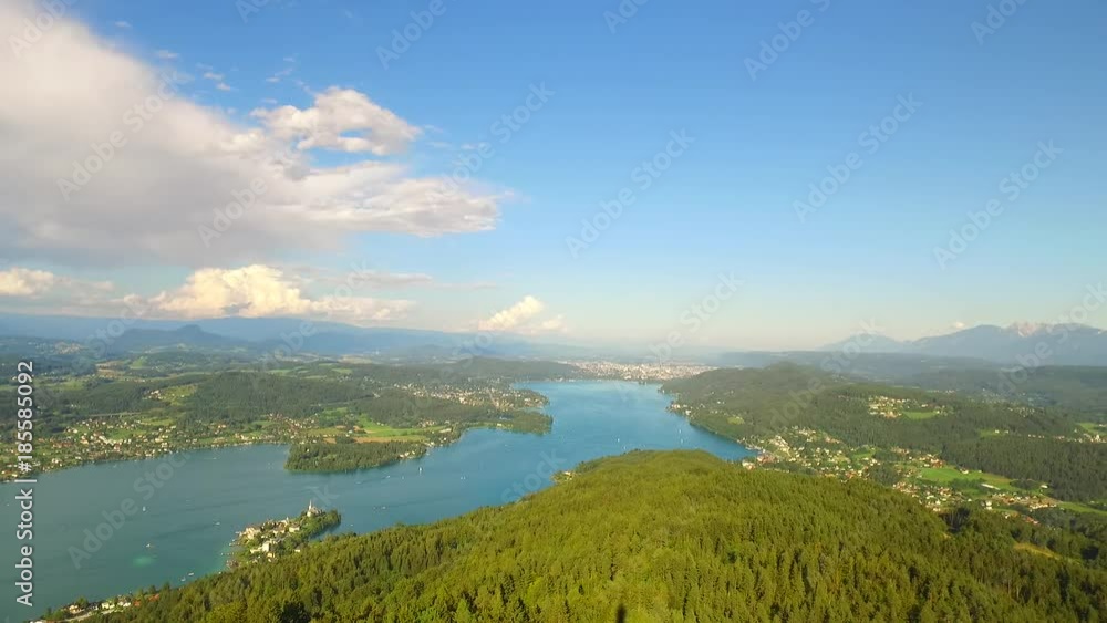Lake WortherSee, Austria, Europe. City Klagenfurt and its surround with beautiful forests and big lake. Summer time. A view from biggest wooden tower in the world, PyramidenKogel, 300 ft high. Lake WortherSee, Austria, Europe. City Klagenfurt and its surround with beautiful forests and big lake. Summer time. A view from biggest wooden tower in the world, PyramidenKogel, 300 ft high.