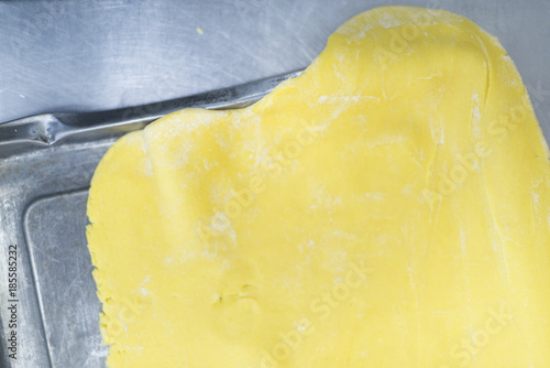 Working out the dough for pasta and cakes in the kitchen photo