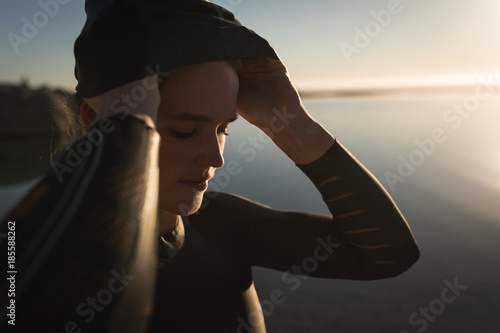 Woman getting ready to swim in the ocean at sunset