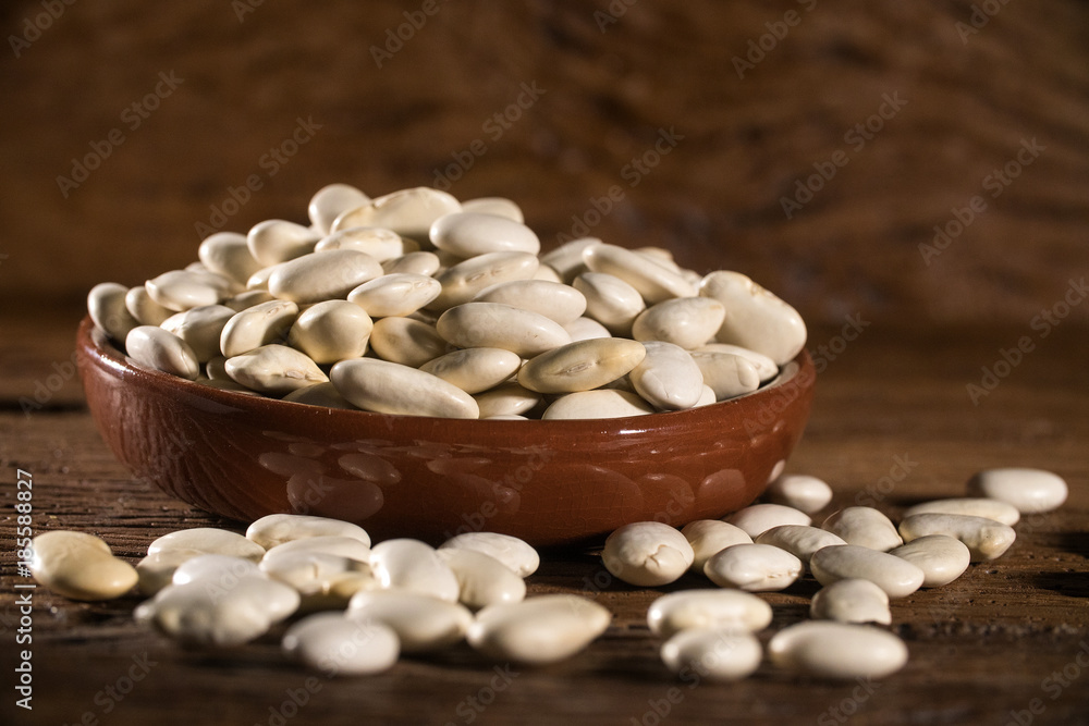 White beans on wood background