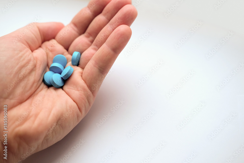 hand of man holding pills hand of man holding pills