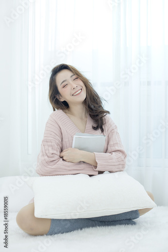Attractive Asian Woman Holding book with happy emotion, People lifestyle concept.