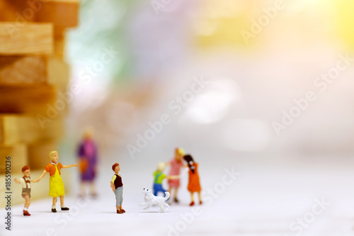 Miniature people, children and family enjoy with dog , happy family day concept.