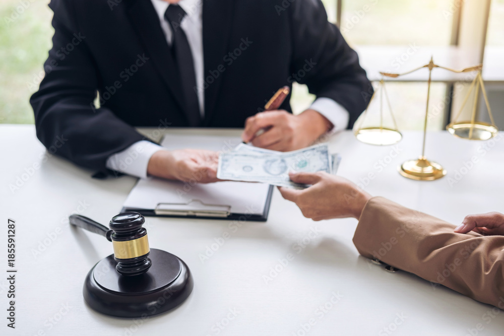Bribery and corruption concept, bribe in the form of dollar bills, Businesswoman giving money to male lawyer while helps making deal to agreement a real estate contract and financial corporate Bribery and corruption concept, bribe in the form of dollar bills, Businesswoman giving money to male lawyer while helps making deal to agreement a real estate contract and financial corporate