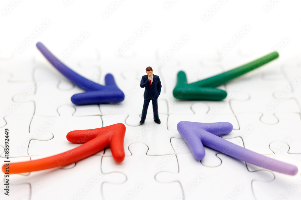 Miniature people standing whit arrow pathway choice. Business decision concept. Miniature people standing whit arrow pathway choice. Business decision concept.