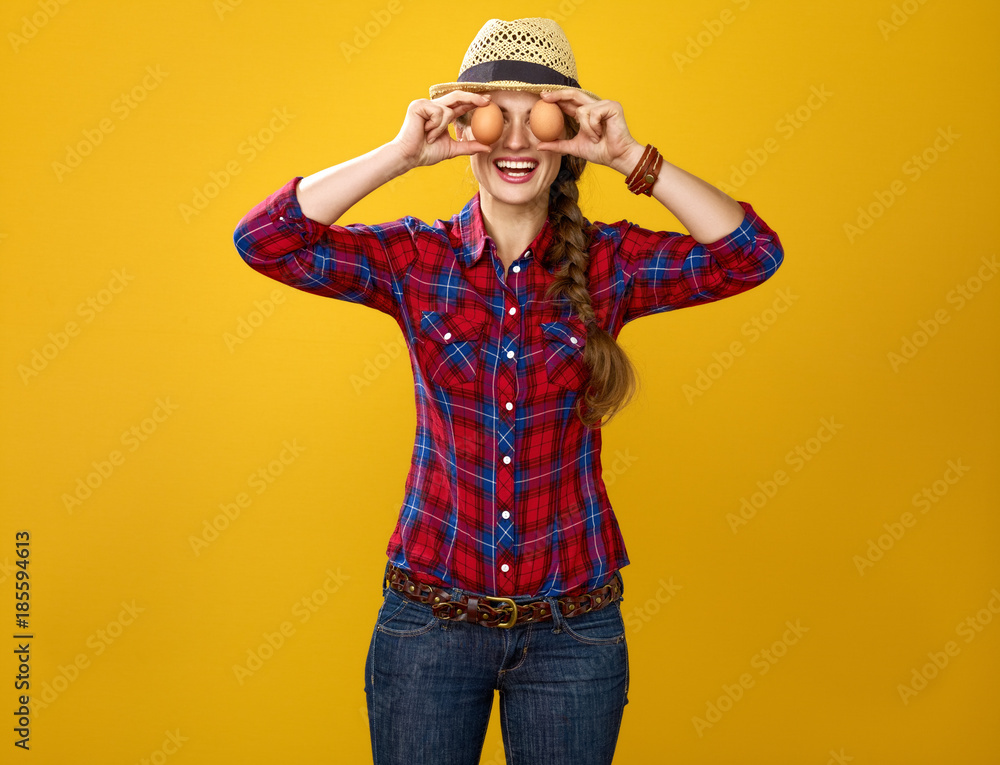 Fototapeta premium happy woman grower holding eggs in front of face like eyes
