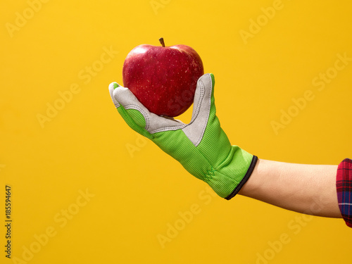 Closeup on modern woman grower showing an apple