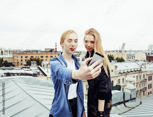 two cool blond real girls friends making selfie on roof top, lif photo