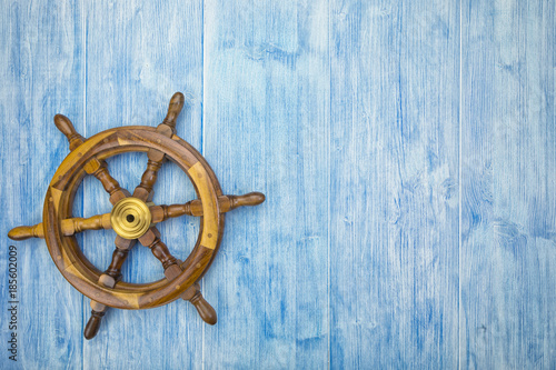 maritime background with helm on blue wood photo