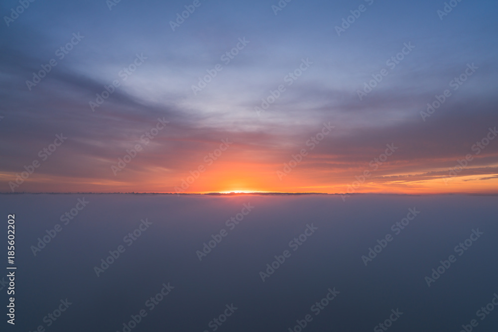 smoke over ocean with red sunset clouds backgrounds