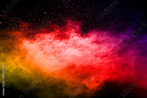 abstract powder splatted background. Colorful powder explosion on black background. Colored cloud. Colorful dust explode. Paint Holi.