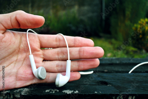 Outdoor photography of earphone and hand object at the garden