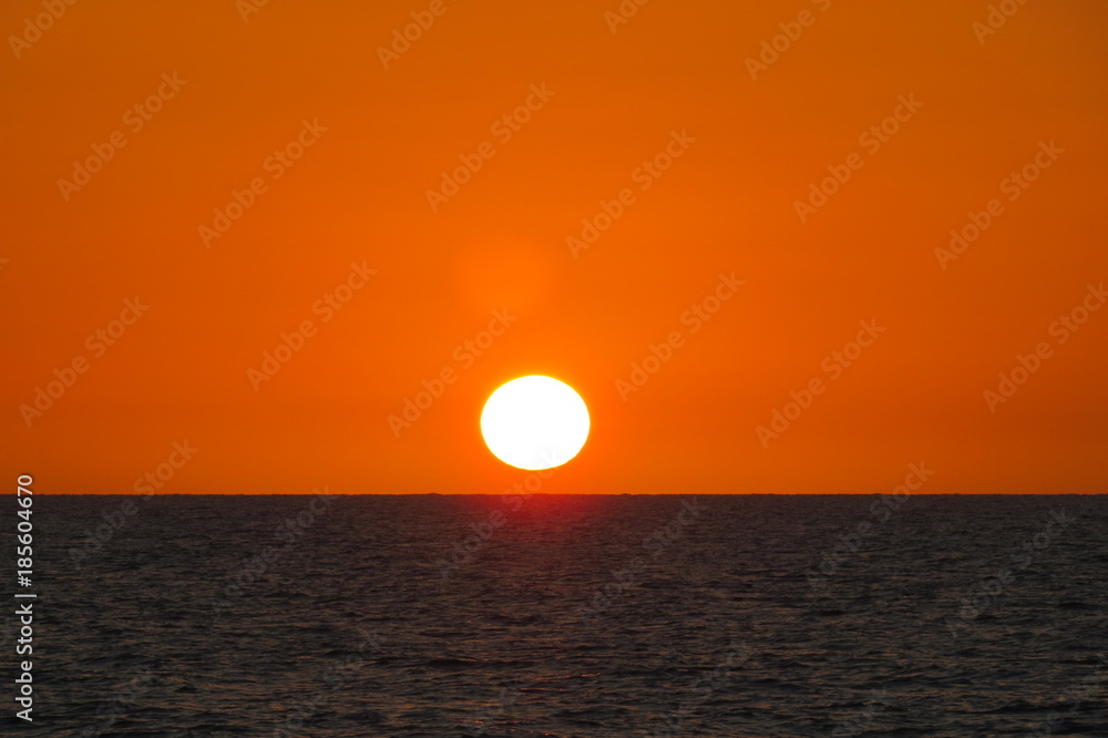 sunset on ocean red orange sinking sun in sea sunset on ocean red orange sinking sun in sea