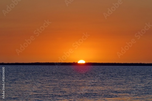 sunset on ocean red orange sinking sun in sea