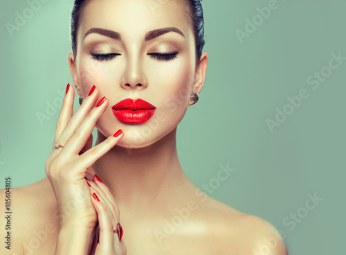 Beautiful fashion sexy woman with red lipstick and red nails