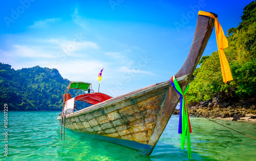 Concept of travel and relax. Beautiful local fishing boats on sea blue Railay beach, Krabi Thailand