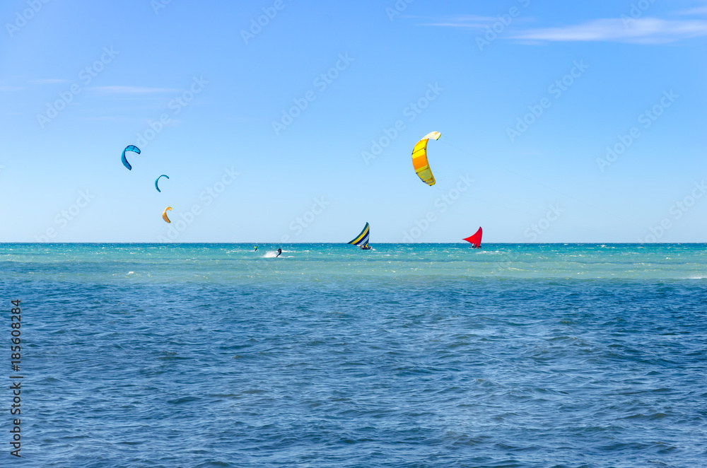 Jangada boat and kite surfers sailing together