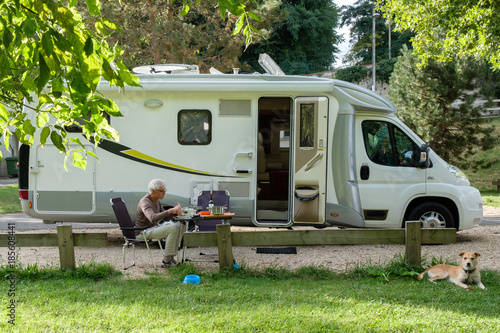 man sit and eat near camper van