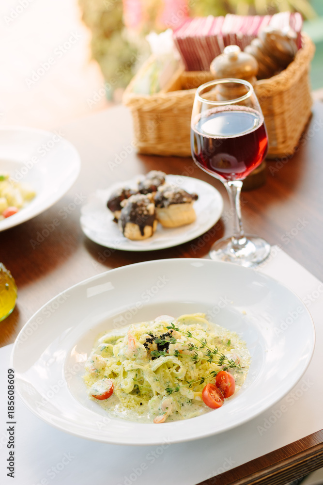 Italian food - fettuccine pasta and pesto sauce with seafood. Italian food - fettuccine pasta and pesto sauce with seafood.