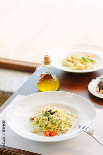Traditional italian fettuccine pasta with pesto in italian restaurant.