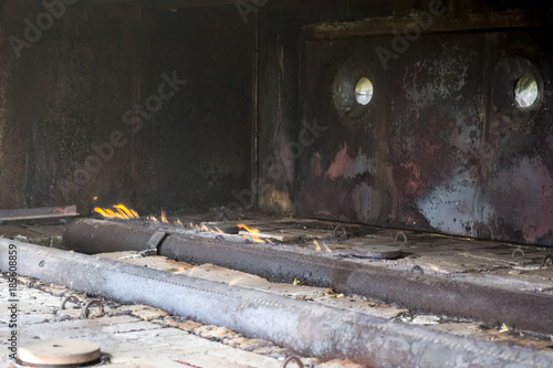 Gas burners at a station for the heating of reservoir fluid. The liquid from the ground is cold and enters the stove where it is heated. Furnace furnace photo
