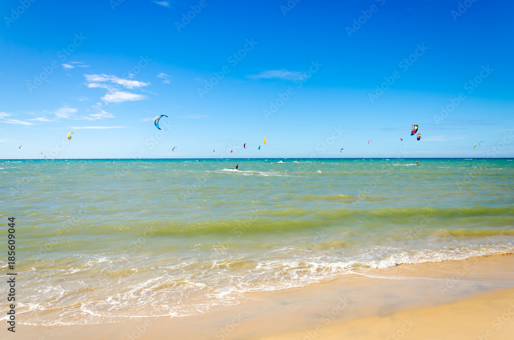 Several kite surfing on the air at the Cumbuco